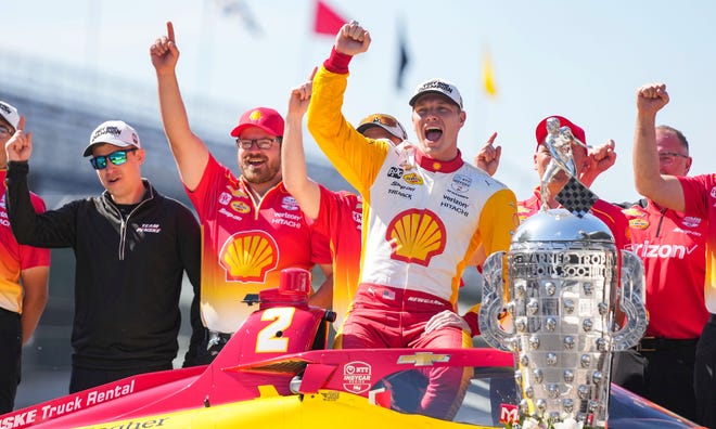 Team Penske driver Josef Newgarden (2) is photographed with the Borg-Warner Trophy after winning the 107th running of the Indianapolis 500 Monday, May 29, 2023, at Indianapolis Motor Speedway.