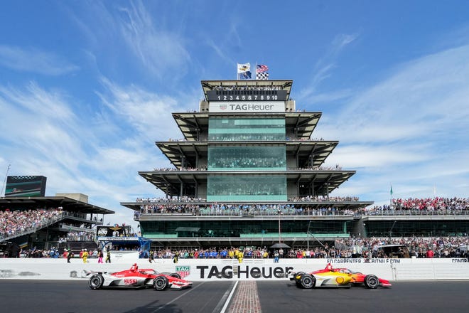 Team Penske driver Josef Newgarden (2) crosses the yard of bricks ahead of Chip Ganassi Racing driver Marcus Ericsson (8) on Sunday, May 28, 2023, to win the 107th running of the Indianapolis 500 at Indianapolis Motor Speedway.