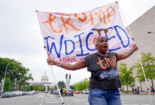 Nadine Seiler demonstrates outside of the E. Barrett Prettyman United States Courthouse before Former President Donald Trump arrives to be arraigned on four charges related to the 2020 election. Federal prosecutors are accusing the Trump of undermining American democracy by organizing a wide-ranging conspiracy to steal the 2020 election that prosecutors allege fueled a brazen and historic insurrection at the U.S. Capitol.