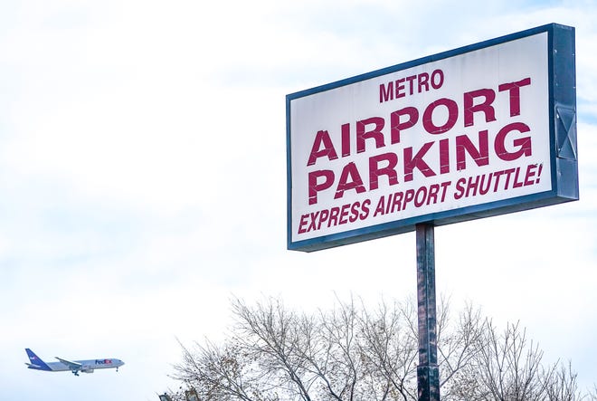 An airplane heads toward the Indianapolis International Airport at Metro Airport Parking next to Mount Olive United Methodist Church on Nov. 30, 2023, in Indianapolis.