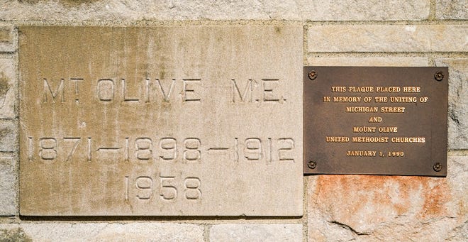 A corner stone reads "Mt. Olive M.E. 1871-1898-1912-1958" and 'Teh Plaque Placed Here in memory of the uniting of Michigan St. and Mount Olive United Methodist Church, Jan. 1, 1990." at Mount Olive United Methodist Church, (1449 S. High School Road) on Nov. 30, 2023, in Indianapolis.