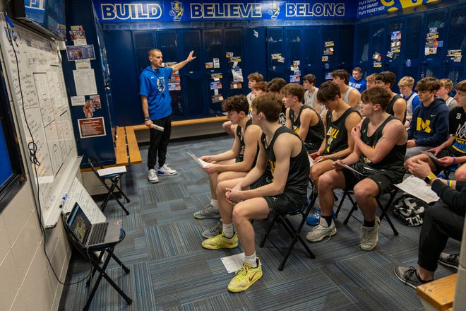 Luke Meredith, head coach, leads a locker-room film session on Tuesday, Feb. 14, 2023, during practice at Greenfield Central High School.