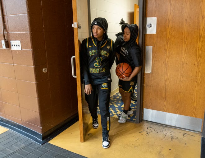 Shyaira Woods leads Indianapolis Crispus Attucks High 
School teammates out of the locker room at Howe Academy, Indianapolis, Tuesday, Jan. 24, 2023, before a game won by Purdue Polytechnic, 56-32. Woods is recovering from a back injury suffered in a car crash.
