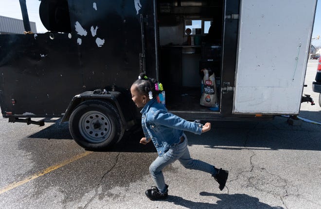 Maríe Campbell, 5, runs around the food truck owned by her dad Timmy Campbell, on Thursday, March 2, 2023, in the Fall Creek Place neighborhood of Indianapolis.