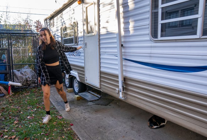 Noa Burns, 17, leaves a small travel trailer next to her family’s home in the Emerson Heights neighborhood of Indianapolis, Thursday, Nov. 2, 2023, where she likes to use as a hangout of sorts. Burns is getting ready to go to a nearby performance of the pop group 1975 with a couple of friends.