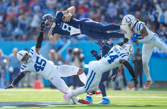Tennessee Titans quarterback Will Levis (8) scrambles and jumps over Indianapolis Colts linebacker E.J. Speed (45), linebacker Zaire Franklin (44) and cornerback Kenny Moore II (23), on Sunday, Dec. 3, 2023, during NFL week 13 at Nissan Stadium in Nashville, Tenn.