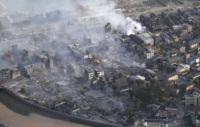 Smoke rises from the site of a fire occurred following an earthquake in Wajima, Ishikawa prefecture, Japan Tuesday, Jan. 2, 2024.