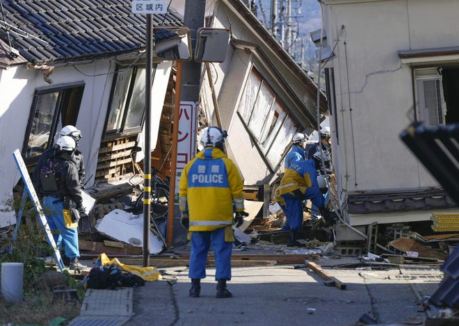 Police make rescue operation at collapsed building following earthquake in Wajima, Ishikawa prefecture, Japan Tuesday, Jan. 2, 2024.