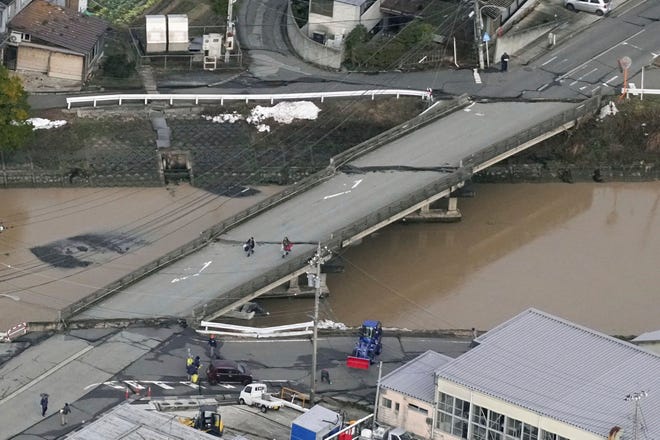 Cracks are seen on a bridge following an earthquake in Suzu, Ishikawa prefecture, Japan Tuesday, Jan. 2, 2024. A series of powerful earthquakes hit western Japan, damaging buildings, vehicles and boats, with officials warning people in some areas on Tuesday to stay away from their homes because of a risk of more strong quakes.
