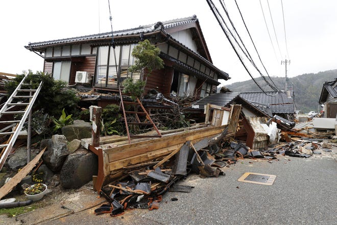 Damaged houses sit following an earthquake in Wajima, Ishikawa prefecture, Japan Tuesday, Jan. 2, 2024.