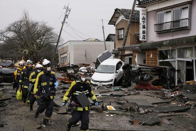 Firefighters search the earthquake-hit area in Suzu, Ishikawa prefecture, Japan, Wednesday, Jan. 3, 2024. A series of powerful earthquakes that hit western Japan left multiple people dead Wednesday as rescue workers fought to save those feared trapped under the rubble of collapsed buildings.