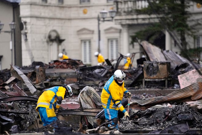 Police officers search victims of a fire caused by powerful earthquake in Wajima in the Noto peninsula facing the Sea of Japan, northwest of Tokyo, Sunday, Jan. 7, 2024. Monday's temblor decimated houses, twisted and scarred roads and scattered boats like toys in the waters, and prompted tsunami warnings.