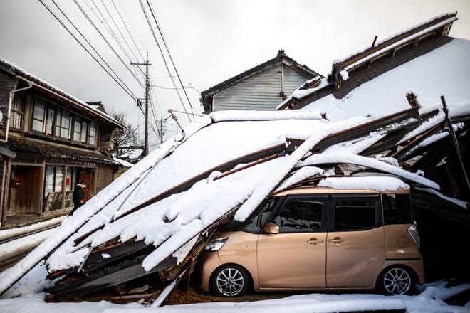 A damaged car lies underneath a collapsed building at Shika town in Hakui District, Ishikawa Prefecture on January 8, 2024 after a major 7.5 magnitude earthquake struck the Noto region on New Year's Day.