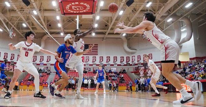 Center Grove Trojans forward Will Spellman (42) reaches for the the ball Saturday, Jan. 13, 2024, during the Johnson County finals at Center Grove High School in Greenwood. The Center Grove Trojans defeated Whiteland, 68-43.