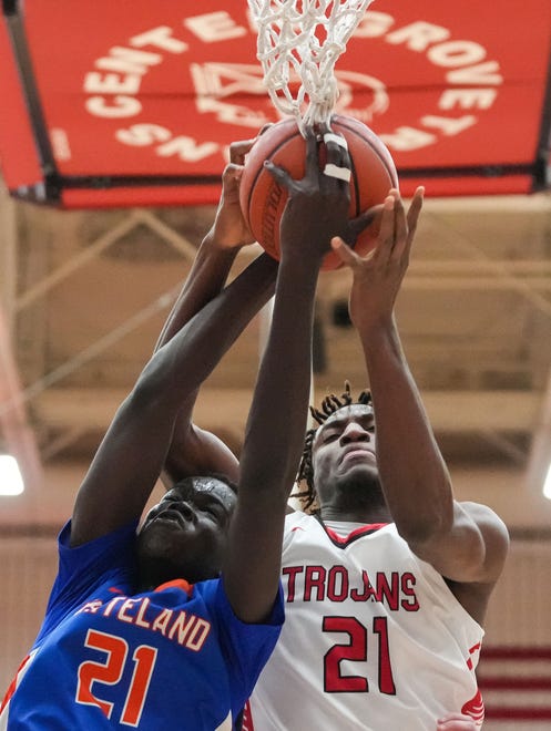 Whiteland's forward Akol Akol (21) leaps for the ball against Center Grove Trojans forward Michael Ephraim (21) on Saturday, Jan. 13, 2024, during the Johnson County finals at Center Grove High School in Greenwood. The Center Grove Trojans defeated Whiteland, 68-43.