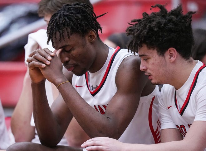 Center Grove Trojans forward Michael Ephraim (21) sits not he sidelines Saturday, Jan. 13, 2024, ahead of the Johnson County finals at Center Grove High School in Greenwood. The Center Grove Trojans defeated Whiteland, 68-43.