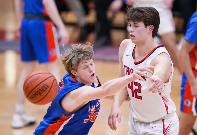 Whiteland's guard Ethan Edwards (32) reaches for the ball against Center Grove Trojans forward Will Spellman (42) on Saturday, Jan. 13, 2024, during the Johnson County finals at Center Grove High School in Greenwood. The Center Grove Trojans defeated Whiteland, 68-43.