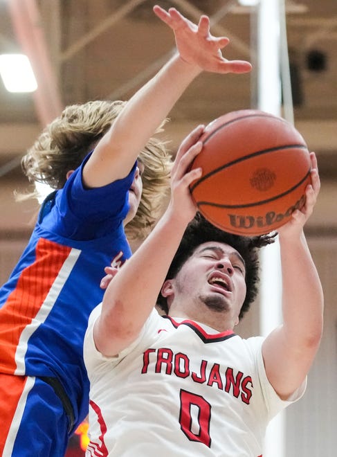 Center Grove Trojans guard Jalen Bundy (0) goes up for a layup Saturday, Jan. 13, 2024, during the Johnson County finals at Center Grove High School in Greenwood. The Center Grove Trojans defeated Whiteland, 68-43.
