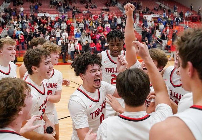 Center Grove Trojans yell in excitement Saturday, Jan. 13, 2024, during the Johnson County finals at Center Grove High School in Greenwood. The Center Grove Trojans defeated Whiteland, 68-43.