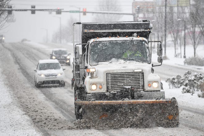 A plow truck drives down Magnolia Avenue in East Knoxville, during a snowstorm, Monday, Jan. 15, 2024.