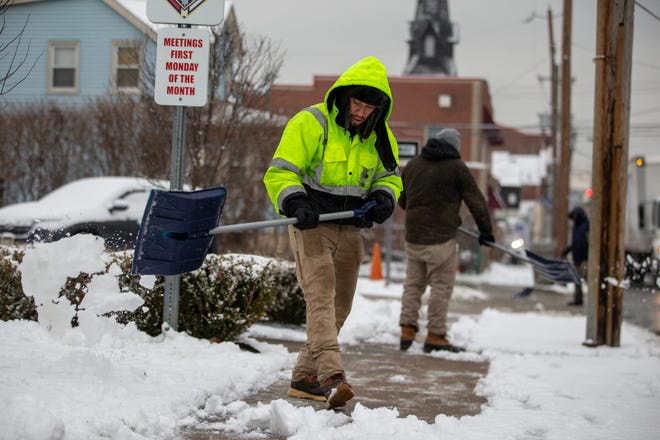 Francisco Lopez of Old Bridge shovels snow from the sidewalk in front of Our Lady of Fatima on Broad Street in Keyport, NJ Tuesday Jan. 16, 2024.